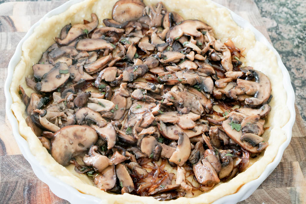 Layer wild mushrooms on top of the caramelized onions.